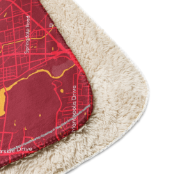 Close-up of a red Custom Map Blanket showing the printed map design and soft sherpa-style backing.