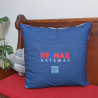 Custom map pillow shown from the back, featuring a blue fabric design with a RE/MAX Gateway logo and QR code.